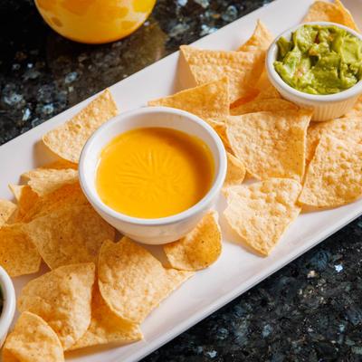Mexican cheese dip, served with chips and guacamole