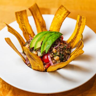 Vegetarian ceviche, with cherry tomato, chickpeas, quinoa, avocado, and plantain strips.