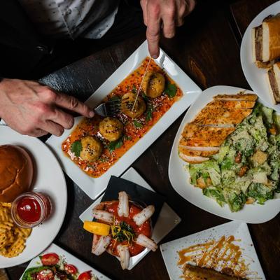 A table spread of various dishes in a restaurant setting.