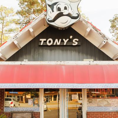 Store front with entrance and a sign.