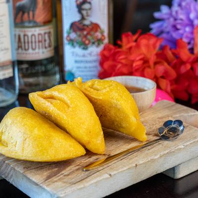 Empanadas with chicken, beef, or cheese with aji sauce.