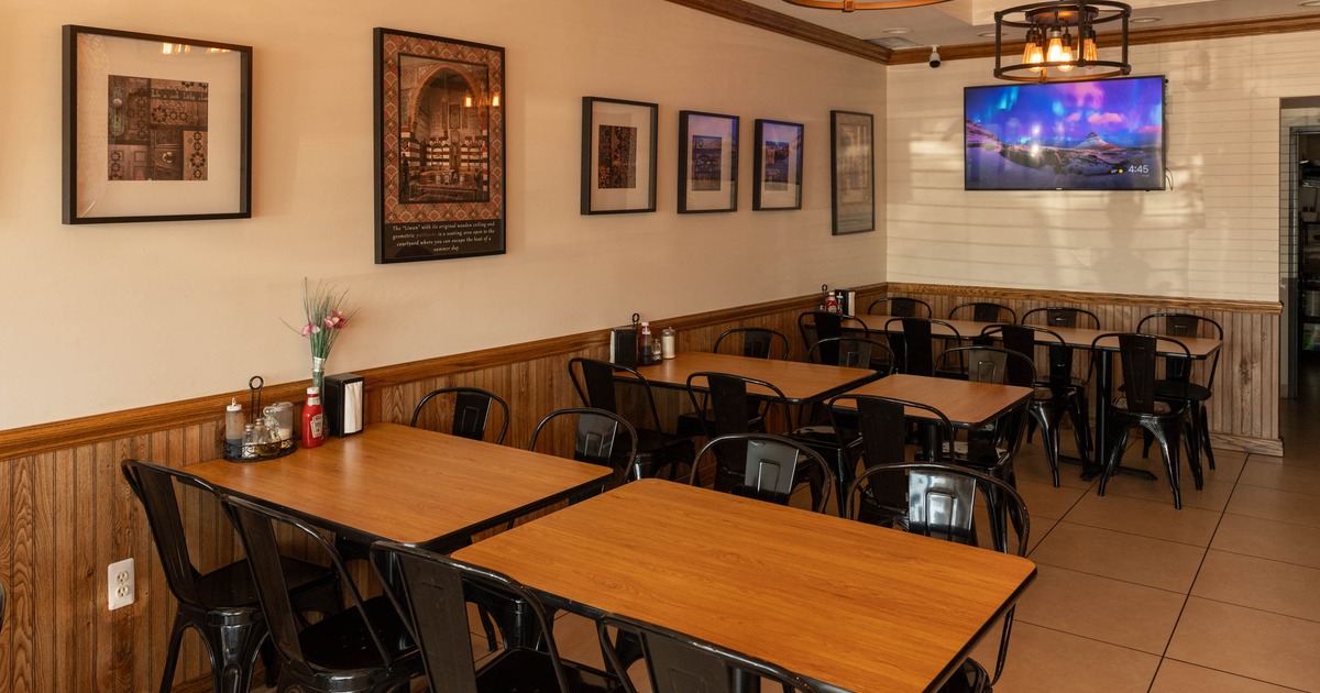 Interior, dining area, tables for eight and six, ready for guests, tile flooring