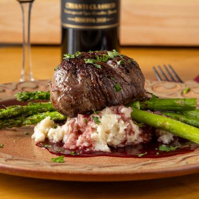 Beef filet served with grilled asparagus, potato pure and a red wine reduction.