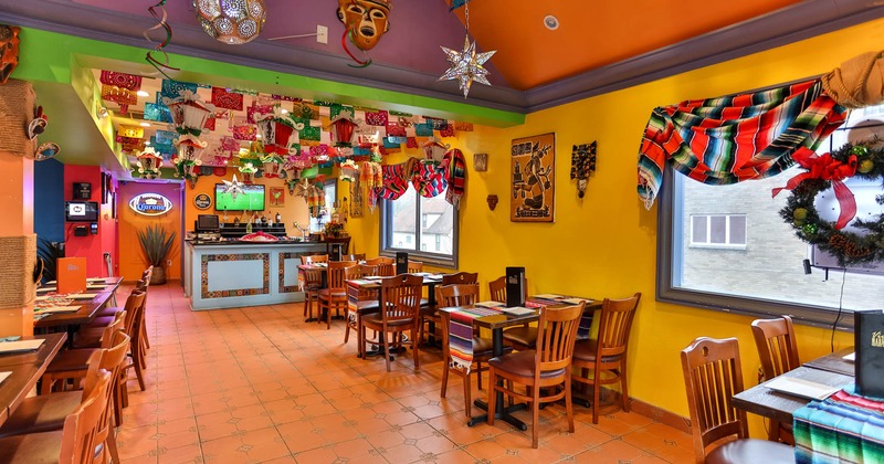 Dining area ready for guests, bar in the background