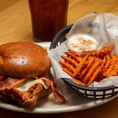 Fried Chicken Sandwich served with waffle sweet potato fries and a dipping sauce.