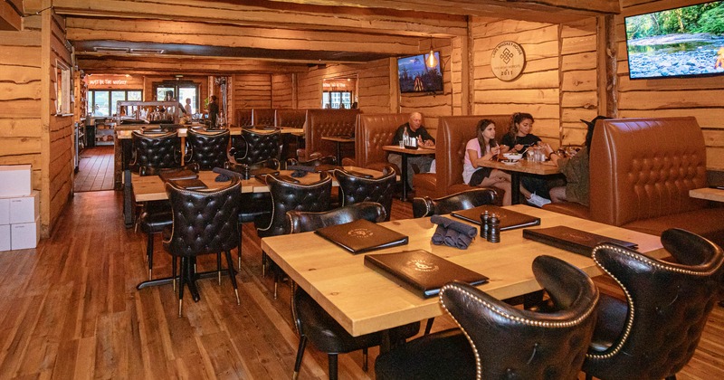 Interior, dining tables and booths, with guests dining