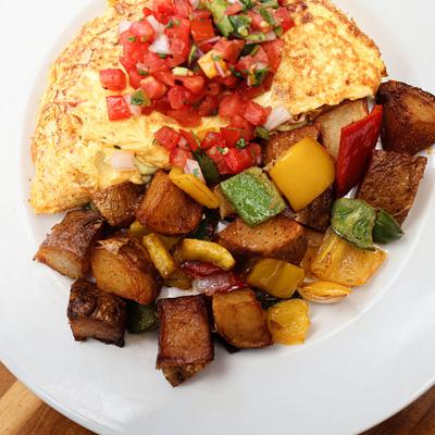 Omelet, with green and red peppers, tomatoes, black beans, salsa, and potatoes.