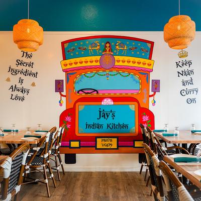 Interior, dining room with colorful mural art.
