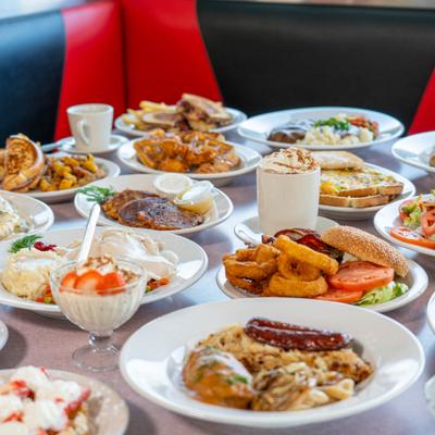 Variety of dishes served on the table with drinks.