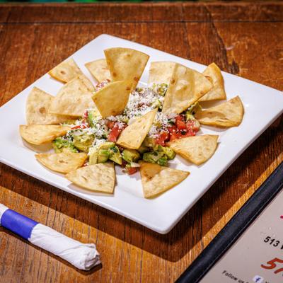 Guacamole topped with pico de gallo and crumbled cheese, served with tortilla chips.