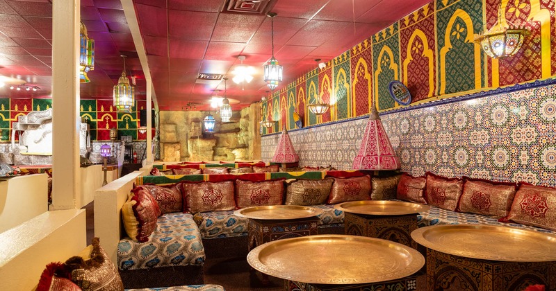 Dining area with couches, pillows and lamps