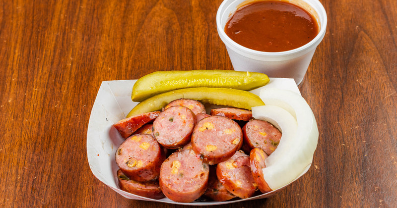 Grilled sausage, salad and dip on the side