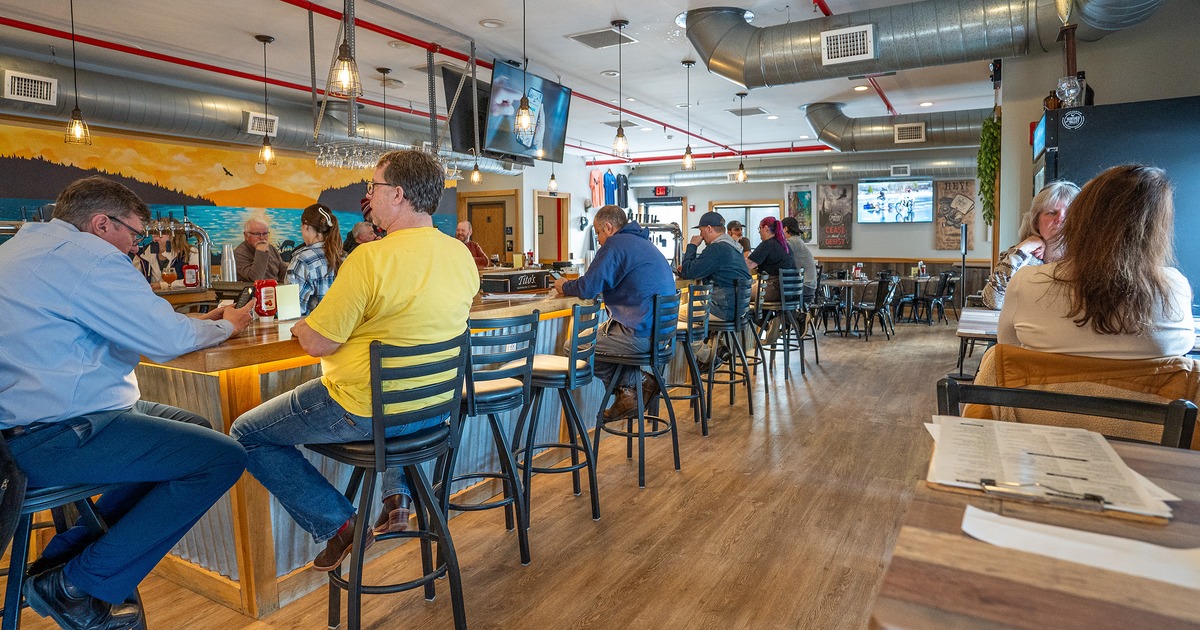 Interior seating area and bar area with guests