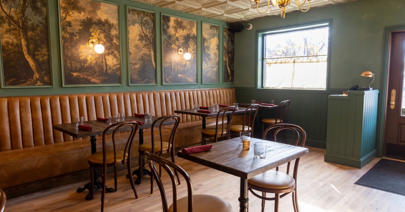 Cozy dining area, wooden tables and chairs set for guests