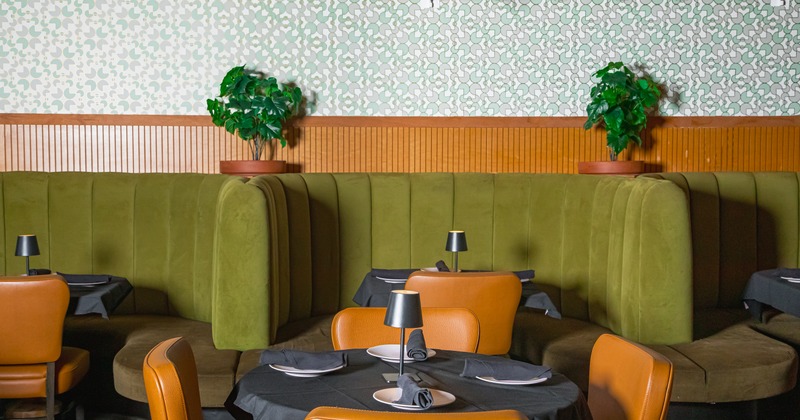 Interior with dining booths, tables and leather chairs