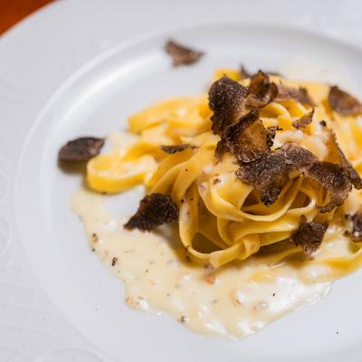 Fettuccine pasta with cheese and black truffles.