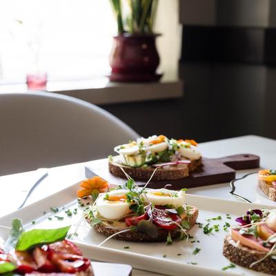 Assorted food plates displayed on a table in dining setting.