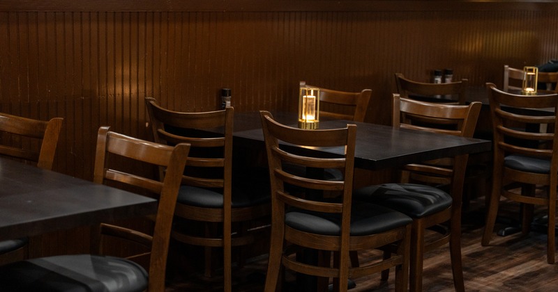 Interior, dining space with wooden panels on walls, tables and chairs