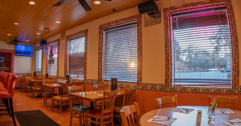 Interior, dining area, wooden top tables with chairs, windows with blinds