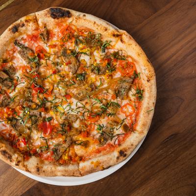 Pizza with sausage, peppers, peppadews, and caramelized onions