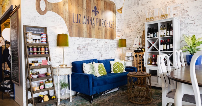 Lounge area with blue seating and a wine display