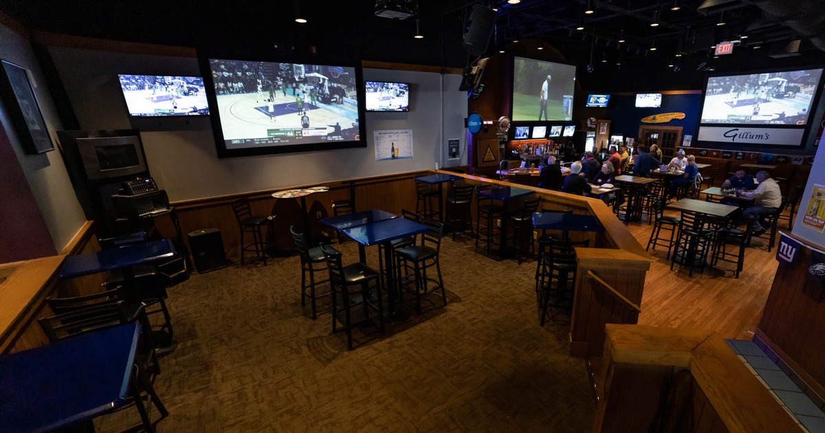 Interior, tables and chairs, TV screens on the wall