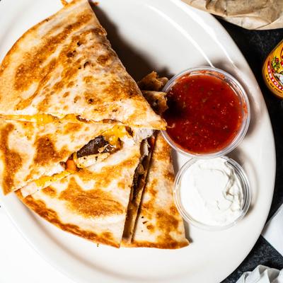 Chicken quesadilla served with homemade salsa and sour cream.
