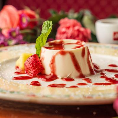 Panna cotta topped with berry sauce.