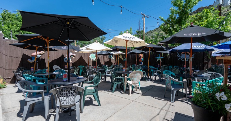 Outdoor, seating area with tables, chairs and parasols