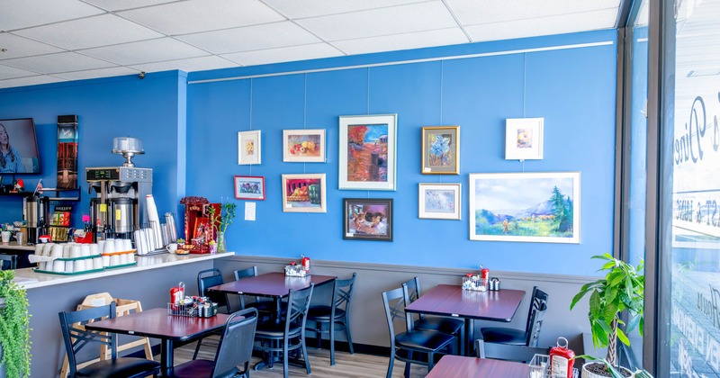 Interior, dining area with framed wall paintings