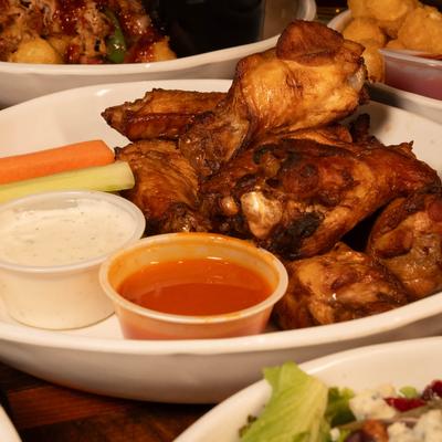 Our house made chicken wings are delicious, served with your choice of sauce..