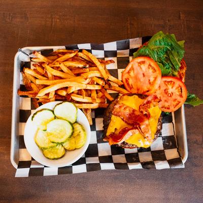 Bacon cheeseburger, served with zucchini and fries
