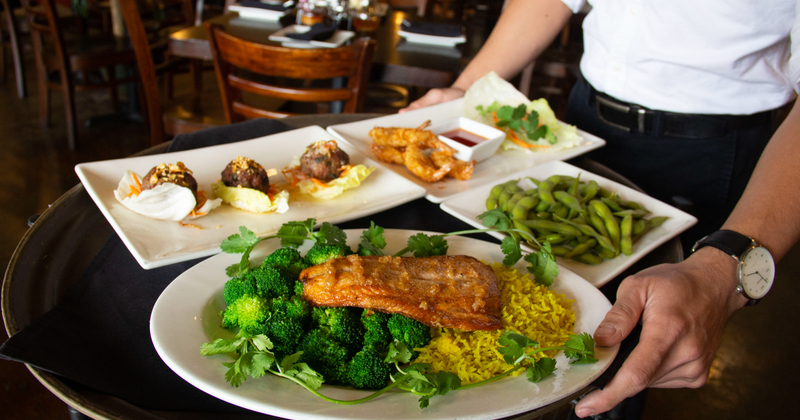 Staff member presenting several dishes