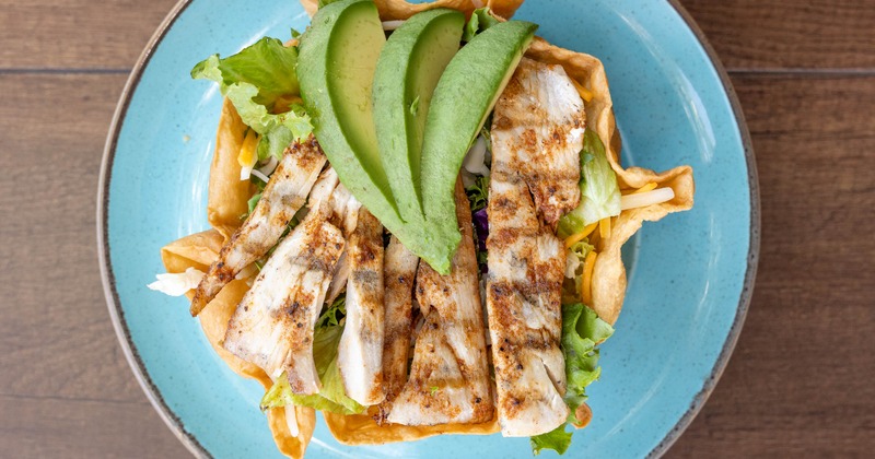 Shrimp Salad in fried tortilla bowl, topped with avocado, overhead view