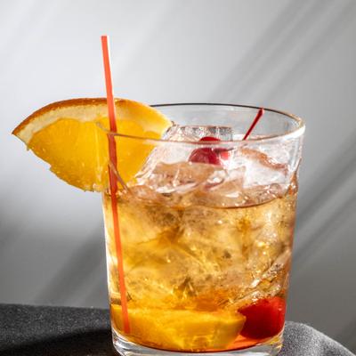 Old Fashioned decorated with cherry and orange slice.