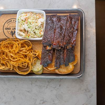 Smoked rib platter, with toast, onion straws, and coleslaw.