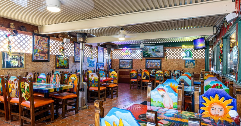 Interior, decorated tables and chairs, tv screens, ceiling fans