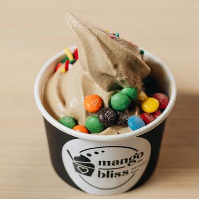 Peanut butter frozen yogurt topped with chocolate candies.