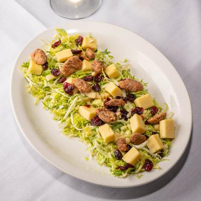 Shaved brussels sprouts, with lettuce, cheese, cranberries, pecans, apples, and vinaigrette.