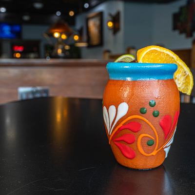 Cocktail in a colorful clay cup.