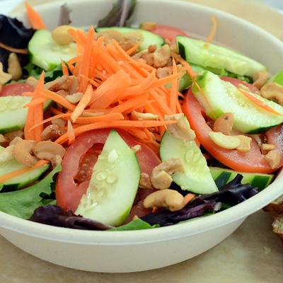 Garden Greens salad with mixed greens, tomatoes, cucumbers and grated carrots.
