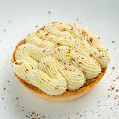 Pastry tart topped with swirled cream.