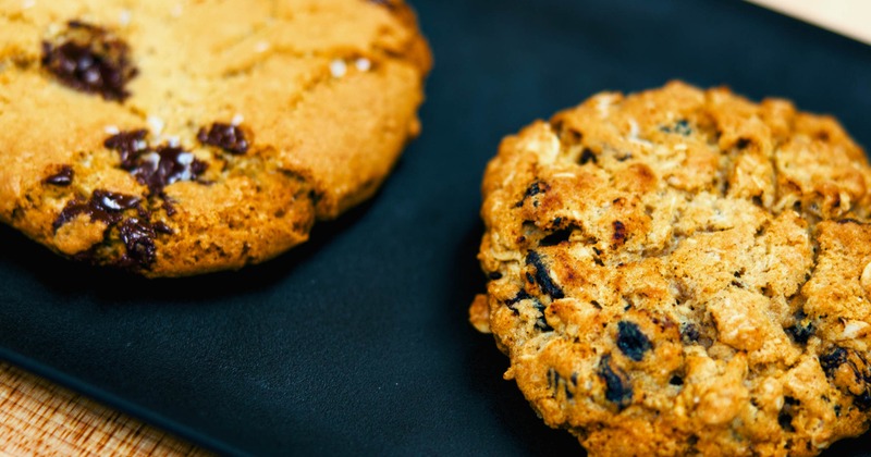 Two cookies served on a black platter