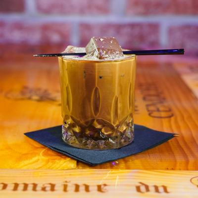 Iced coffee cocktail drizzled with caramel.