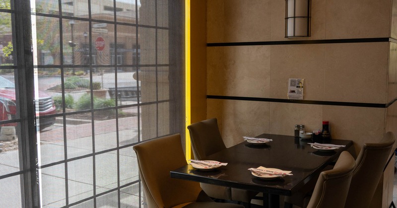 Interior, tables and chairs next to the window