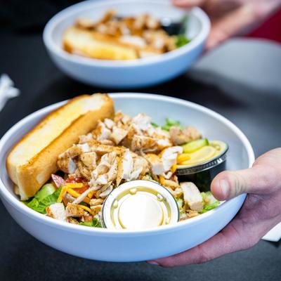 House Salad with chicken, toasted bread, ranch sauce and honey mustard.