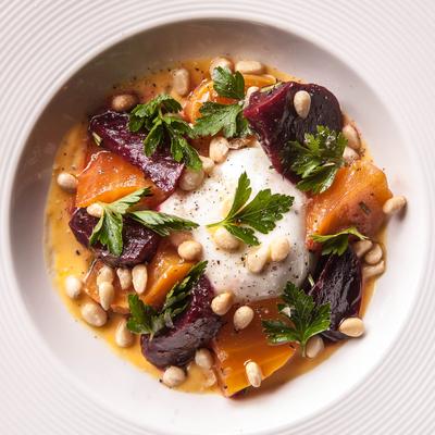 Beet and burrata salad with pine nuts and fresh herbs.