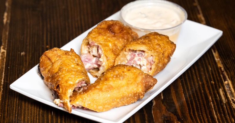 Reuben Egg Rolls, 2 egg rolls filled with corned beef Swiss cheese sauerkraut, and remoulade for dipping