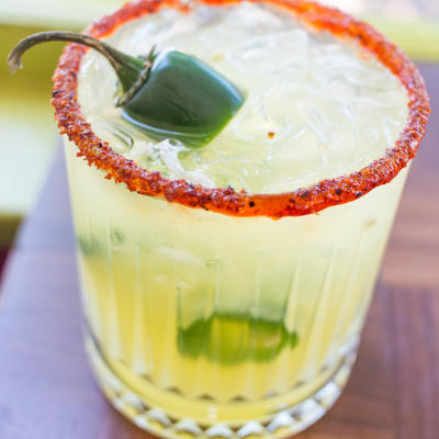 A served margarita with a green pepper.