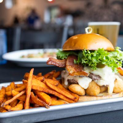 Custom smash burger served with sweet potato fries.
